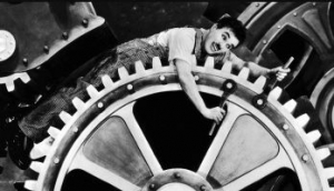 Foto do Charles Chaplin - sobre habitos repetitivos, numa cena de filme em que ele ficava no meio de engrenagens de uma fábrica, realizando tarefas repetitivas, como um robô